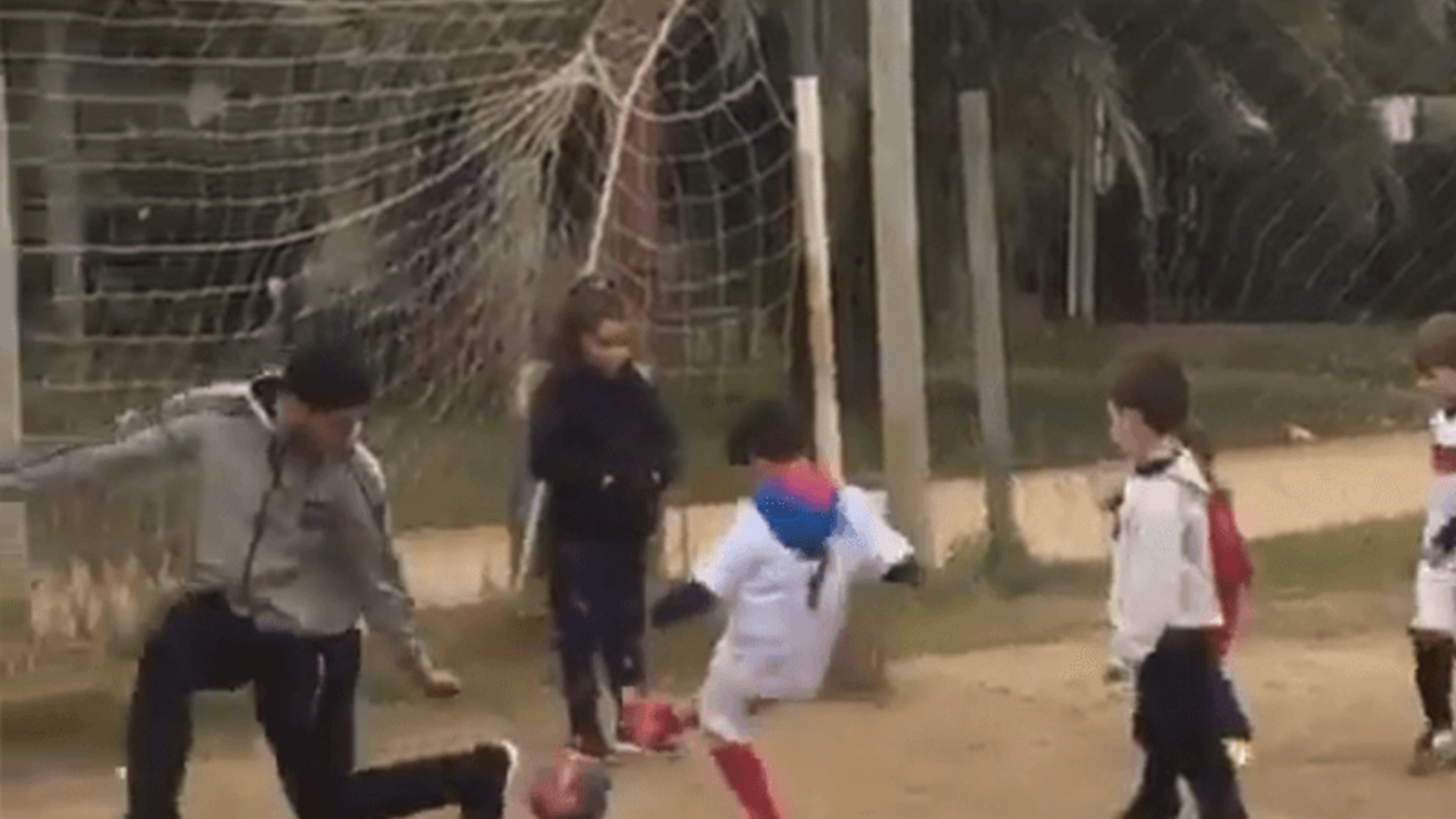 Luis Suarez plays in goal during a kid's street game in Uruguay
